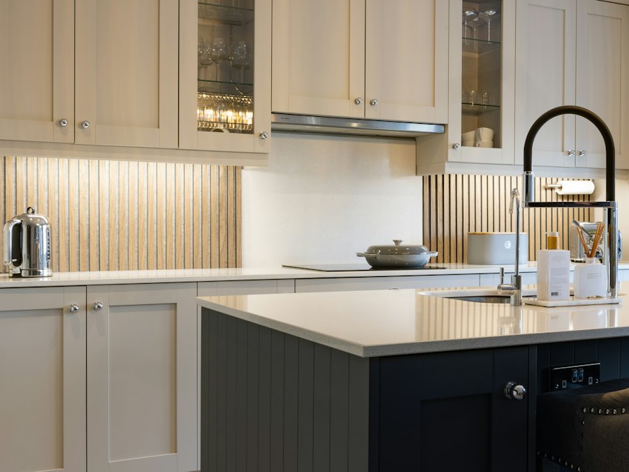 Greige cabinets with a dark painted island